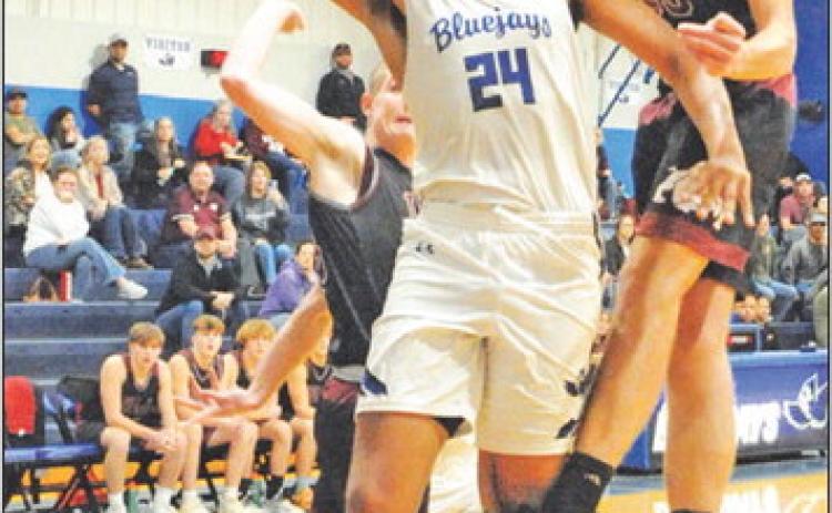 DEKENDRICK DAWSON TAKES a shot dedpite heavy defensive pressure against Iola. -- Tribune photo by Denise Squier