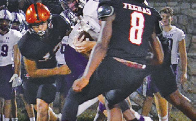 THE SOMERVILLE DEFENSE, including Keke Daniels and Ian Teague move in for a tackle against Thrall.