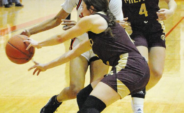 SOMERVILLE’S DESTINY VELA STRUGGLES to drive the ball past a Milano defender during the Lady Yeguas’ win over the Lady Eagles last Friday night in Somerville. -- Tribune photo by Denise Squier