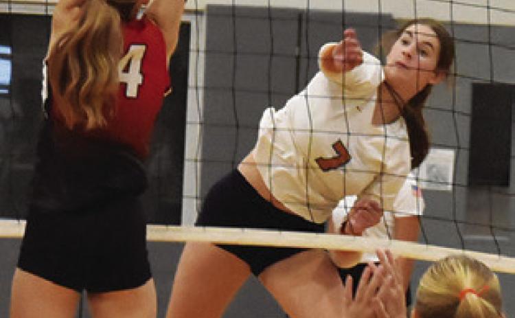 LYDIA GIESE gets the ball past a BVCHEA Homeschool blocker during Caldwell’s win Friday night. This week, Giese reached a milestone of 1,000 career assists. Tribune photo by Roy Sanders