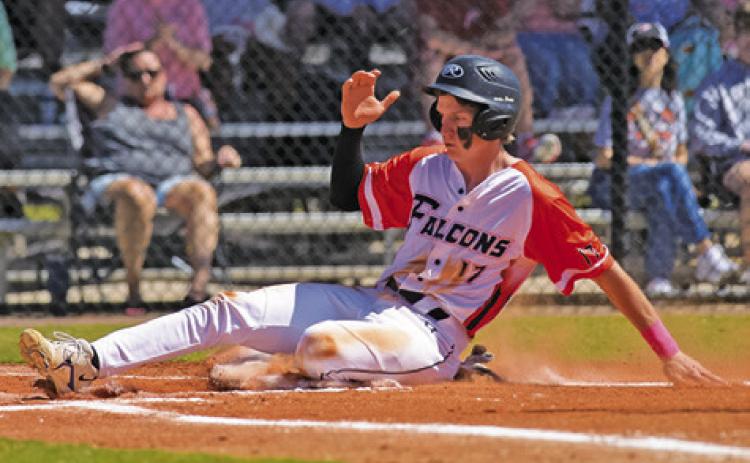 CALDWELL’S DANIEL BARDIN slides into home during the Northside Falcons-Springfield Chargers baseball game at the Homeschool World Series tournament in Auburndale, Florida.