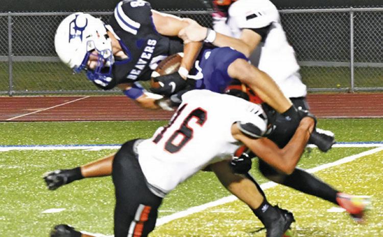 SOMERVILLE DEFENDERS, including Gardner Shivers, front, make a tackle against Falls City. -- Photo by Marian Laskowski