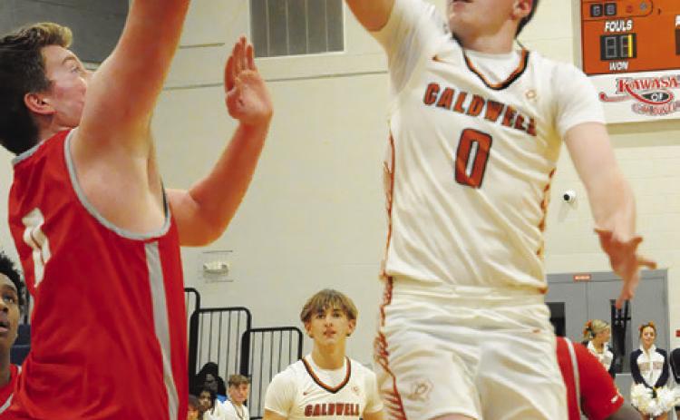 CADEN ZBORIL LEAPS high for this shot last Friday against Bellville. The Hornets lost their last home game 69-49. Tribune photo by Denise Squier