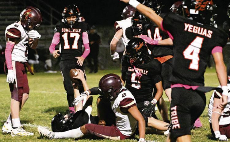 A SOMERVILLE YEGUA recovers a fumble against Milano as teammates look on. They include Landon Discher, Manuel Lucio and Levi Legg. Tribune photo by Denise Squier