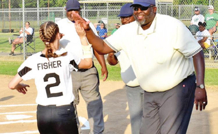 THE UMPIRES WELCOME the players from both teams onto the field prior to Monday’s Columbus-Hempstead softball game.