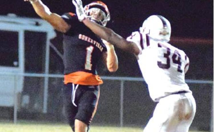 SOMERVILLE’S PHILIP HABA throws the ball away from Flatonia defender Dakory Willis during the Yeguas’ loss to the Bulldogs Friday night at The Rock. -- Tribune photo by Denise Hornaday