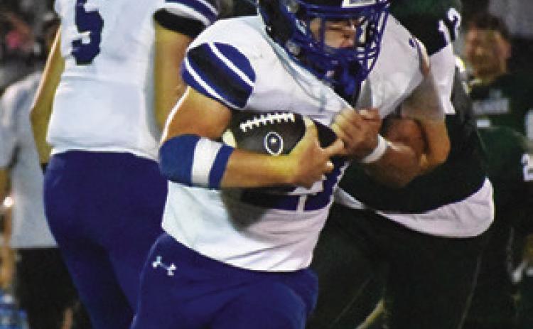 MICHAEL EATON carries the ball for Snook last Friday against Normangee. Tribune photo by Roy Sanders