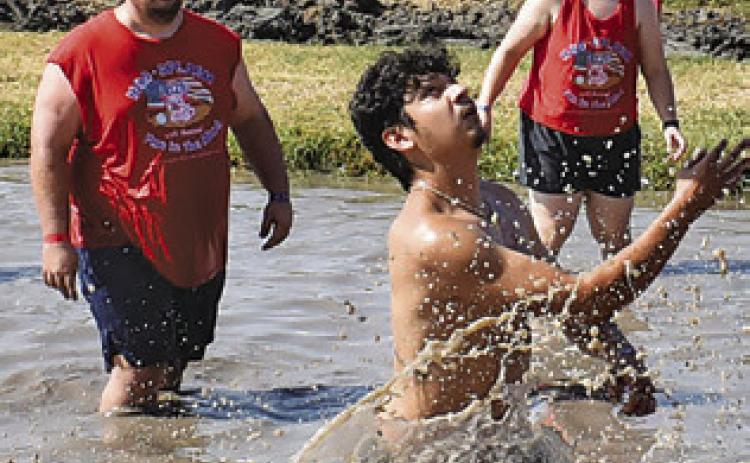 A MUD VOLLEYBALL player goes for the ball last Saturday during Hog Splash 2026 at Slovacek’s in Snook. The popular, annual event benefits Hospice Brazos Valley. Tribune photo by Roy Sanders