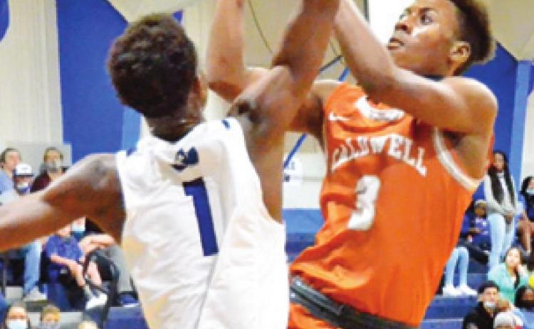 DONTAVIEN JOHNSON of Caldwell shoots as Ma’Darius Hamilton of Snook tries to block the shot. -- Tribune photo by Roy Sanders