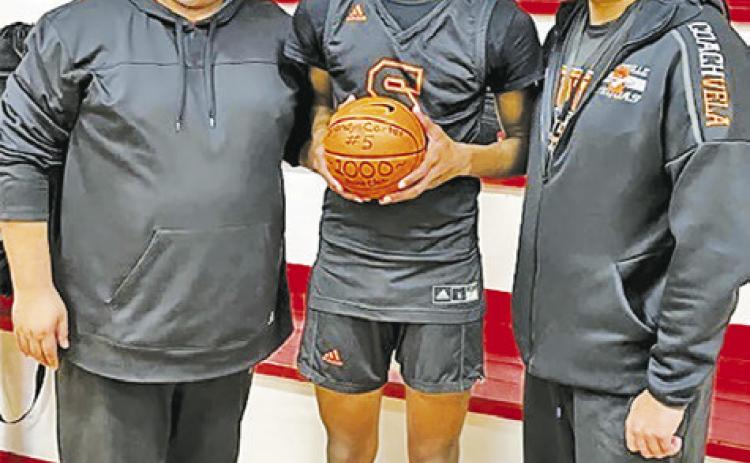 SOMERVILLE’S BRANDYN CARTER IS honored by Head Coach Rene Cantu and Assistant Coach Josh Vela at the Burton game.