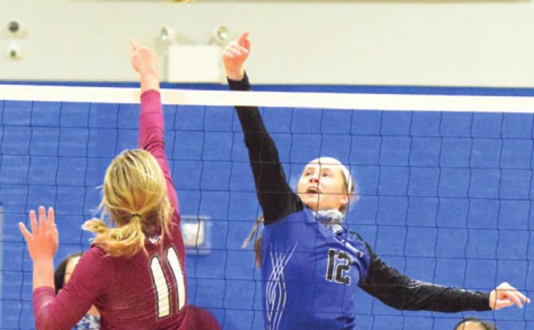 SNOOK’S RILEY GREEN hits the ball over Fayetteville’s Kayme Schley during the Lady Jays’ four-set loss to the Lady Lions last Tuesday night in Snook. -- Tribune photo by Denise Hornaday