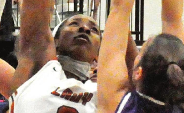 AIYLIYA BELL SHOOTS over Florence’s Abbey Brown in the Lady Hornets’ 47-21 win last Friday night. -- Tribune photo by Roy Sanders