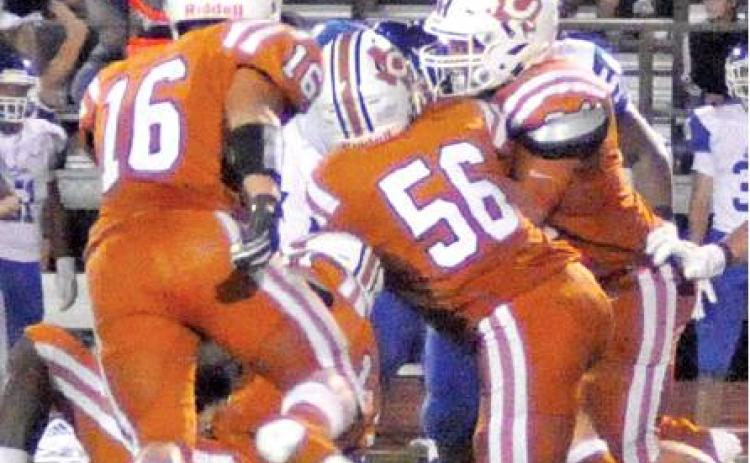 COLLIN GAMMAGE AND Carson Gammage move in for this tackle last Friday against Edna in Caldwell. The Hornets lost 29-16 in the opener and face Rockdale this week. -- Tribune photo by Roy Sanders