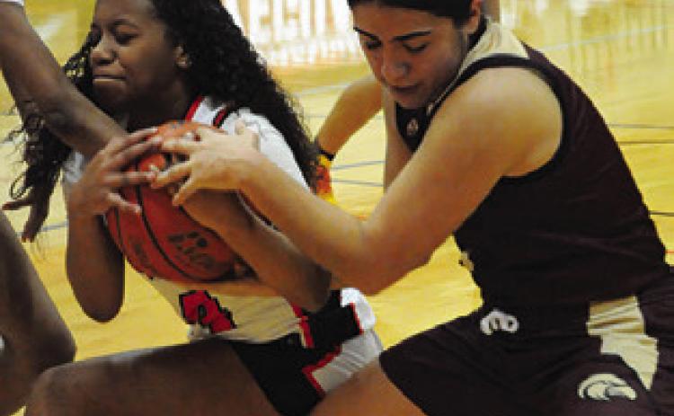 KAMRYN HARRIS wins this battle for possession against a Milano player during Friday’s game. Tribune photo by Denise Squier