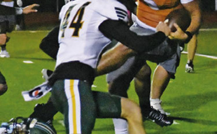 QUARTERBACK JOHN Fryrear fights through these defenders in the Little River Academy game last Friday in Caldwell. Tribune photo by Roy Sanders