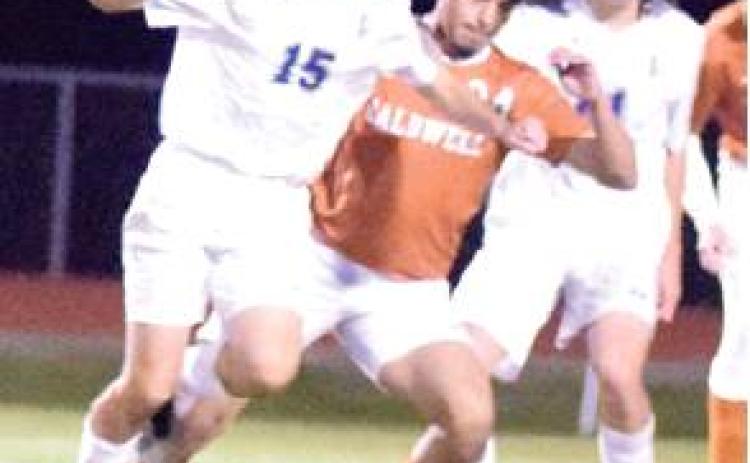 CALDWELL’S CHRIS AMAYA battles with a player from Manor New Tech for possession of the ball. -- Tribune photo by Denise Hornaday