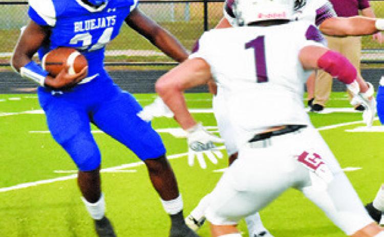 SNOOK’S MARK Moore carries the ball against Iola last Friday in Snook. Snook lost its opener 27-24. -- Tribune photo by Roy Sanders
