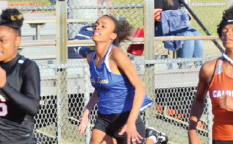 SOMERVILLE’S CAMIA MARTIN flies down the track to win the girls varsity 100-meter dash at the Happy Skrabanek Relays in Caldwell on Friday. Caldwell’s Ja’Asia Mathis placed fourth.