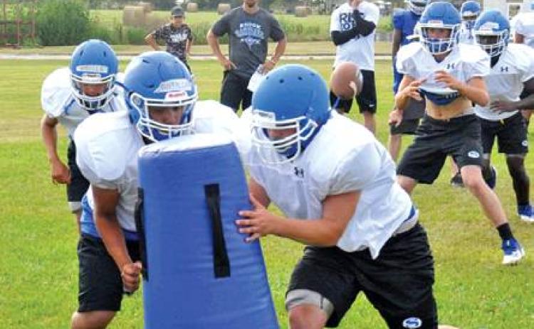 THE SNOOK BLUEJAYS work on their plays during a recent practice session. Snook is getting ready to open its season on Aug. 30 against Granger in Granger. -- Tribune photo by Roy Sanders