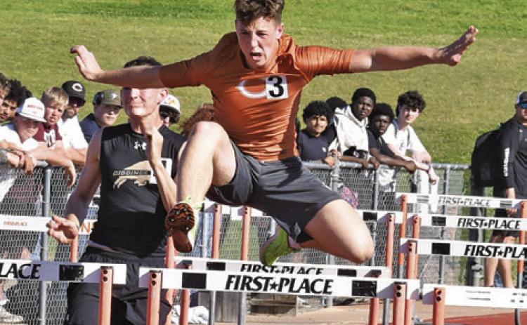 CALDWELL’S KRUSH STRANGE leaps over hurdles during last Thursday’s Happy Skrabanek Relays in Caldwell. Tribune photo by Roy Sanders
