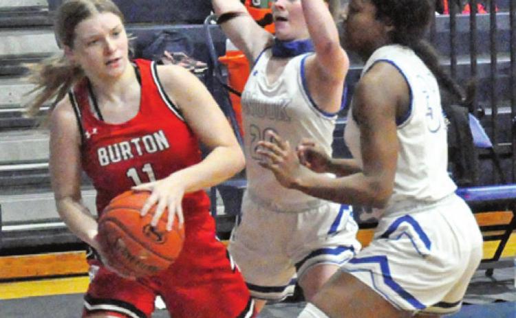 LADY JAY BASKETBALL PLAYERS, Kamree Walker and Jaivan Stringfellow, defend while a Burton player looks for help from a teammate during Snook’s 70-19 win last Friday night at home.