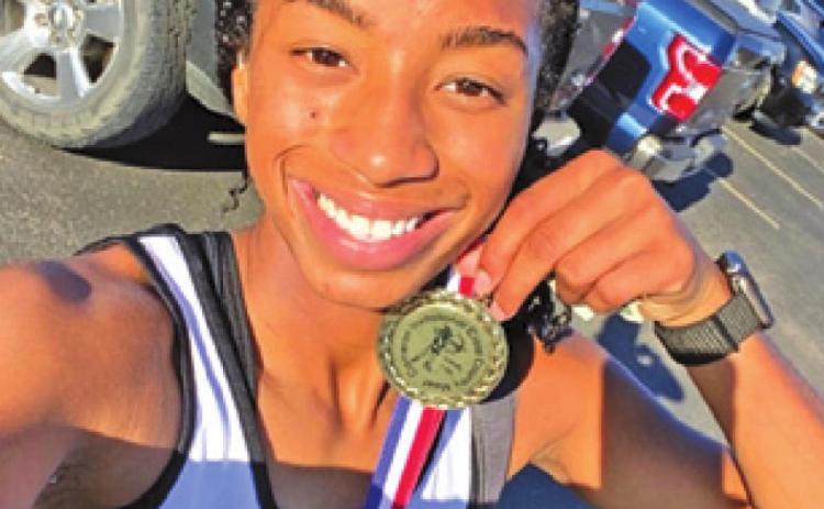 SOMERVILLE CROSS country runner Ra’Maya Carter poses with her medal she earned at last week’s Cameron Invitational.