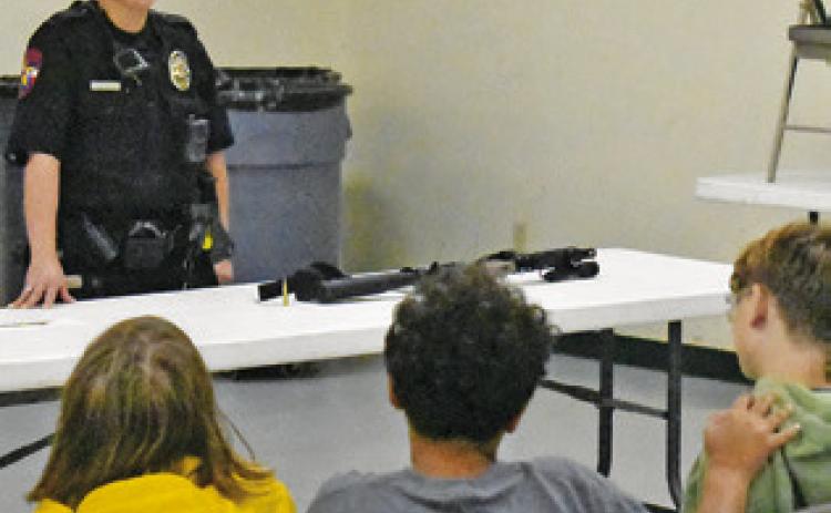CALDWELL POLICE OFFICER Mary Pierce addresses these fifth-graders on Thursday, May 7, at the Burleson County Ag &amp; Health Safety Day at the county expo center. The event was put on by Burleson County 4-H in conjunction with the Burleson County AgriLife Extension.