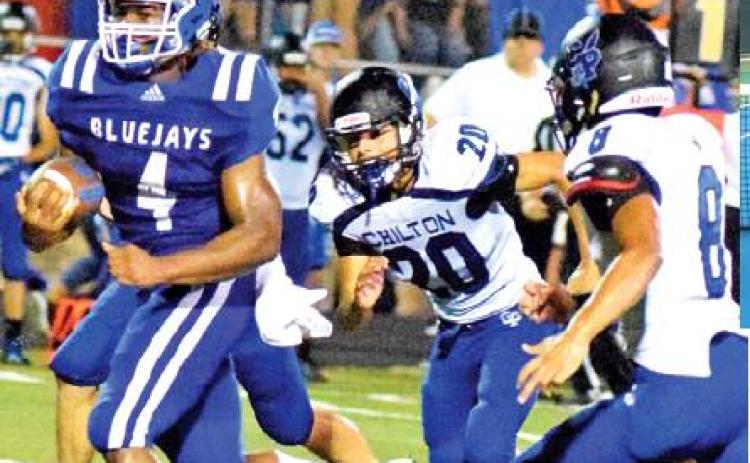SNOOK’S QWAN YOUNG breaks away from these Chilton defenders for a score last Friday at Allen Academy. The Bluejays lost 34-16 and will face Bartlett this week. -- Tribune photo by Denise Hornaday