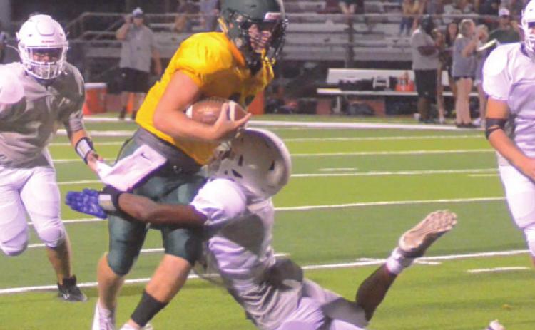 CALDWELL’S LARRY DAVIS makes an open field tackle on a Lexington player during the Hornets’ scrimmage against Lexington last week.