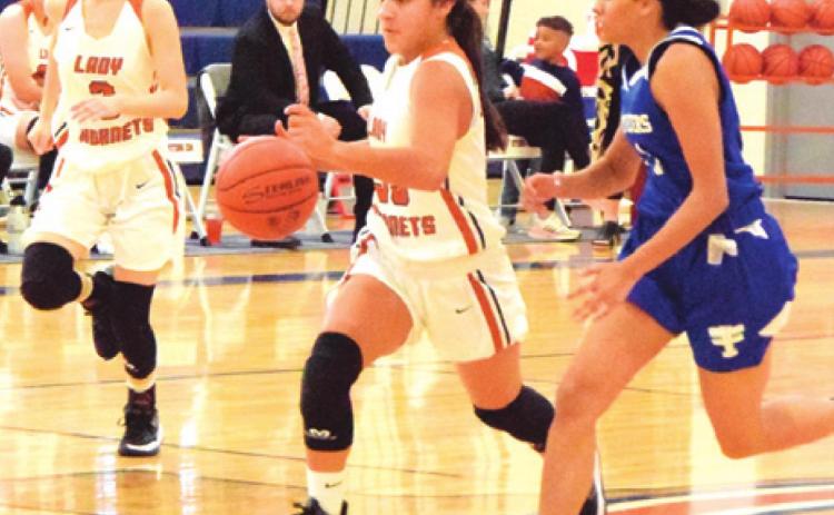 CALDWELL’S ANDREA FLORES drives down the court during the Lady Hornet’s game against Victoria St. Joseph last Tuesday afternoon.