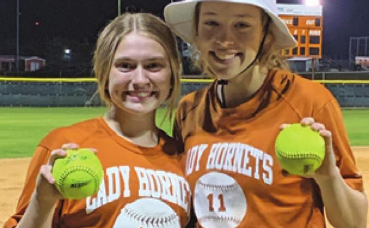 LADY HORNETS, Kelly Urbanovsky, left, and Kyleigh Gomez, right, hit home runs against Bellville in last Monday night’s scrimmage.