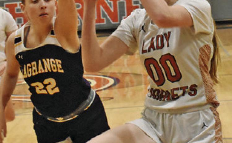THE LADY HORNETS hosted La Grange last Friday with the Lady Leps winning 63-22. TOP: IRELAND MORGAN eyes the basket while La Grange’s Hannah Gross attempts a block. BOTTOM: AMOREE DENSON dribbles around La Grange’s Victoria Harold.