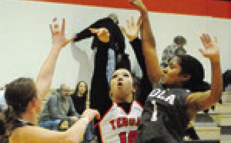 BRYANNA SUROVIK shoots over two Iola defenders during the Somerville-Iola game last week. -- Tribune photo by Denise Squier
