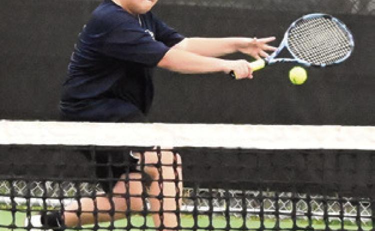 WYATT BEASLEY returns serve during his boys singles match against Franklin’s Jack Stanley last week. Tribune photo by Denise Squier