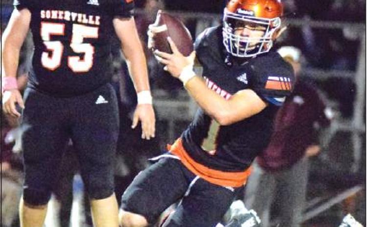 SOMERVILLE QUARTERBACK PHILIP Haba gets away from Flatonia’s Jovanni Venegas during Friday’s district game in Somerville. Also pictured is Riley Eldridge. -- Tribune photo by Denise Hornaday