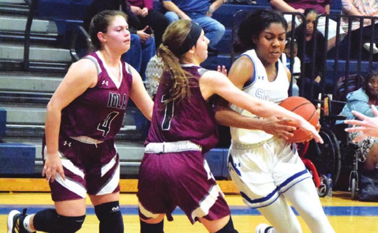 SNOOK’S JAIVAN STRINGFELLOW is fouled while trying to dribble around Iola’s Ava Pointer during the Lady Jay’s 46-27 District 26-2A win over the Iola Lady Bulldogs last Tuesday night. Stringfellow scored seven points for Snook in the victory. -- Tribune photo by Denise Hornaday
