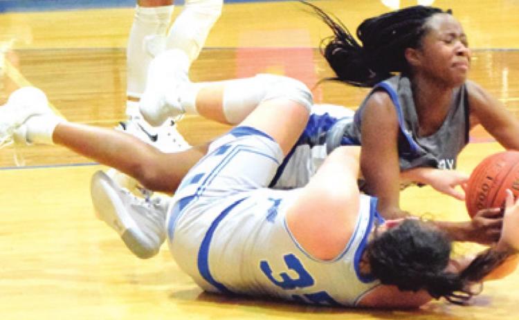 SNOOK’S MACKENZIE GROCE fights for possession of the ball with an Anderson-Shiro player during a tournament game last week.