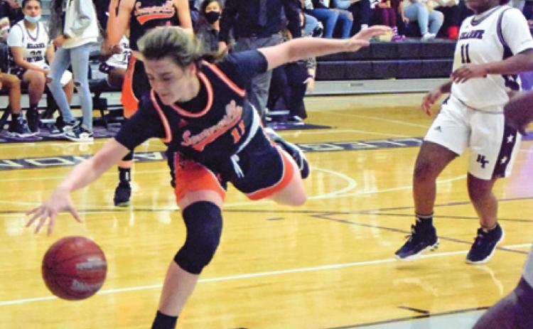 SOMERVILLE’S HALLE STEVENS dives to grab a pass from teammate Ra’Maya Carter during the Lady Yeguas’ area round loss to Hearne last Friday night. -- Tribune photo by Denise Squier