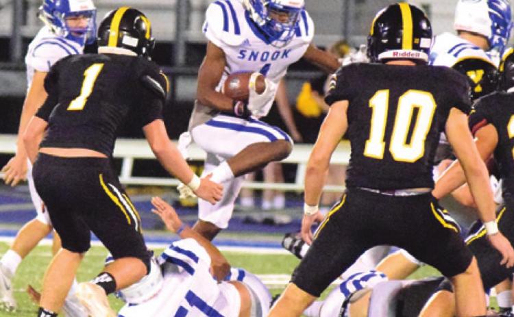 SNOOK’S CAMERON CONERWAY jumps over linemen for positive yardage during the Bluejays’ 52-23 win over Yorktown last Friday night at Altair Rice. -- Tribune photo by Denise Hornaday