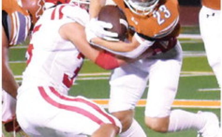 BRANDON FRITCHER of Caldwell carries the ball against Groesbeck in the season opener. Tribune photo by Roy Sanders