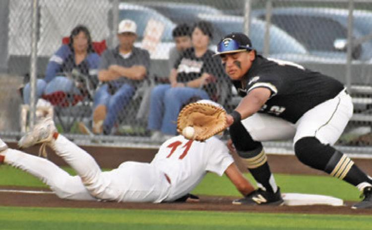 HAYS BEAVERS OF Caldwell slides back into first base. Tribune photo by Roy Sanders