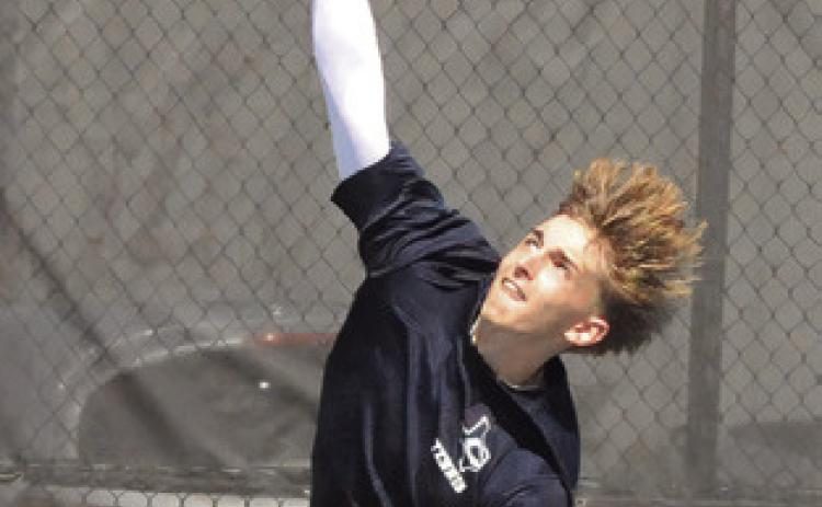 CALDWELL’S DYLAN Chapman serves at the Caldwell Classic Varsity Tennis Tournament. Tribune photo by Denise Squier