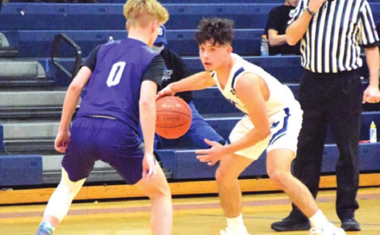 SNOOK’S DAVID DAVILA ATTEMPTS to dribble past an Aggieland HomeSchool player during the Bluejays-Panthers game last Monday night in Snook. -- Tribune photo by Denise Squier-Hornaday