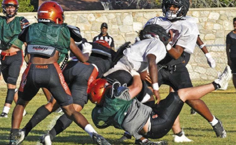 SOMERVILLE’S PETER SALAZAR makes a tackle as teammate Semaj Pennygraph moves in to help. -- Tribune photo by Roy Sanders
