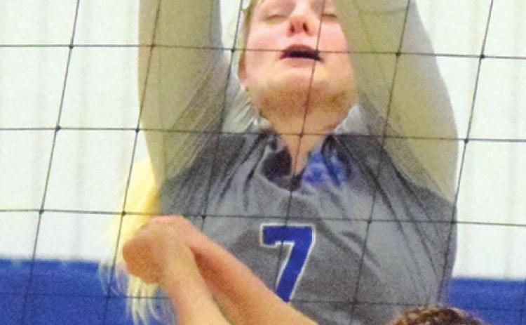 ALEXIS MACIK BLOCKS a hit by a Dime Box player during the Snook-Dime Box district match last week in Dime Box.