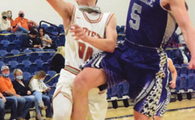 CALDWELL’S LANCE LARA is fouled by a Florence player during Caldwell’s 77-25 win last Friday. -- Tribune photo by Denise Squier