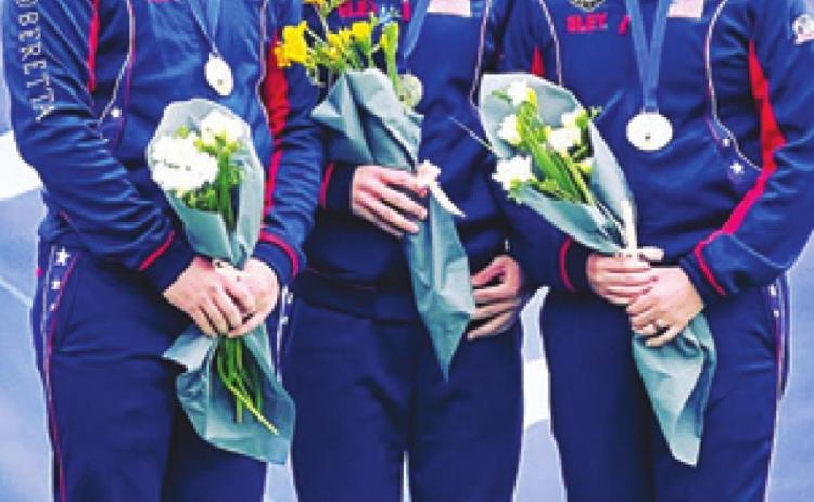 PHILLIP JUNGMAN, left, stands with his teammates, Colt McBee and Hayden Stewart, as they receive their silver medals from competing in the Men’s Skeet Team competition at the World Cup in Cypress last week.