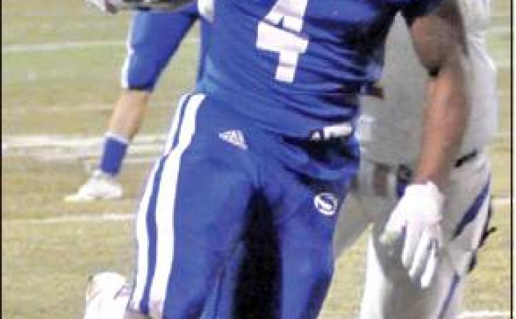 QWAN YOUNG carries the ball for Snook in the Bluejays’ 60-33 victory over the Louise hornets last Friday in Caldwell.