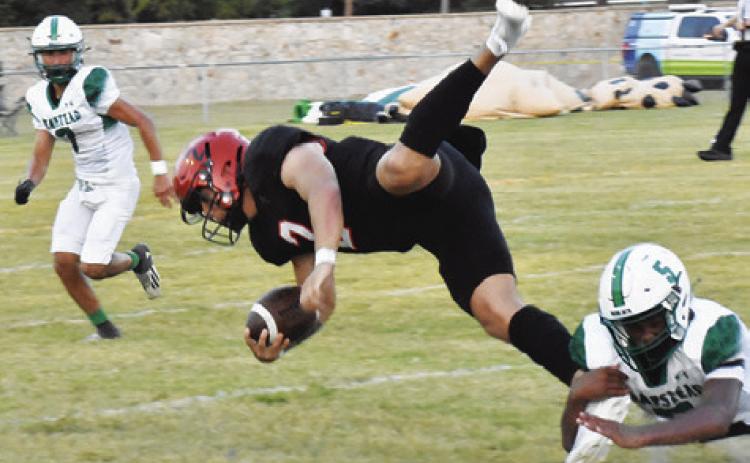 QUARTERBACK IAN Teague is pulled down by this Hempstead defender. The Yeguas won 21-14. Tribune photo by Roy Sanders