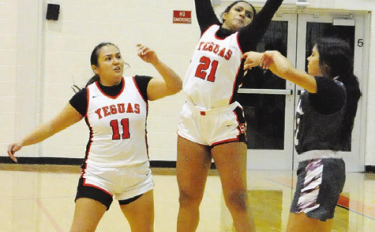 SOMERVILLE’S EMMA WILLIAMS jumps to attempt to block an Iola pass during the Somerville-Iola game last week. Also pictured is Viviana Munoz. -- Tribune photo by Denise Squier